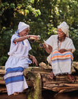 Two women from the Moplaco coffee community in traditional clothing.